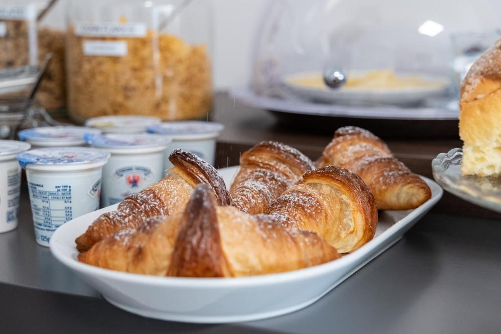 a plate of croissants and other pastries on a counter at B&B I LAKE IT BELLAGIO in Bellagio