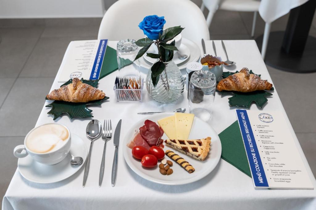 a table with a plate of food and a cup of coffee at B&B I LAKE IT BELLAGIO in Bellagio