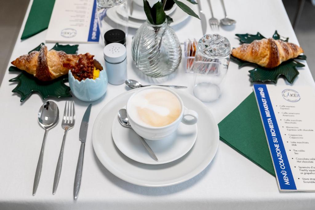 a table topped with a cup of coffee and pastries at B&B I LAKE IT BELLAGIO in Bellagio