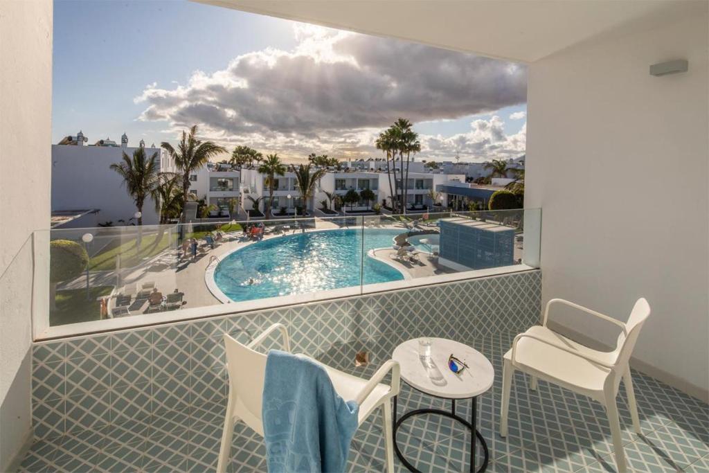 a balcony with a view of a swimming pool at Oasis Lanz Beach Mate in Costa Teguise