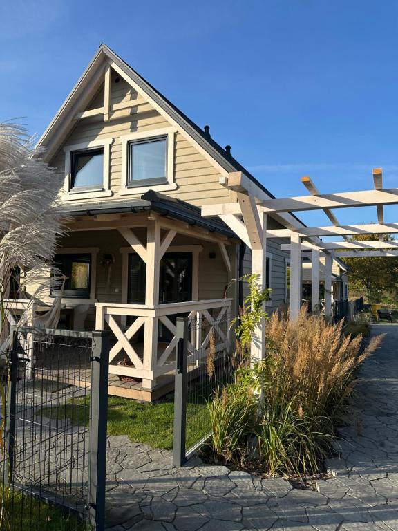 a house with a fence in front of it at Domki Lawendowe in Sasino