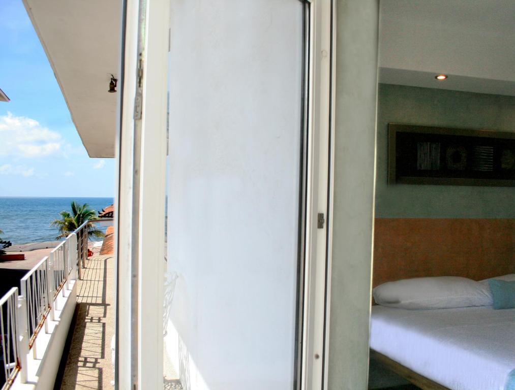 Postel nebo postele na pokoji v ubytování Hotel Rio Malecon