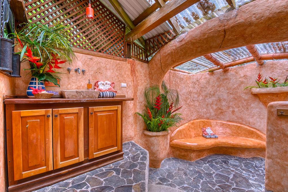 a bathroom with a bath tub and a sink at Tree House Beachfront Lodge in Puerto Viejo