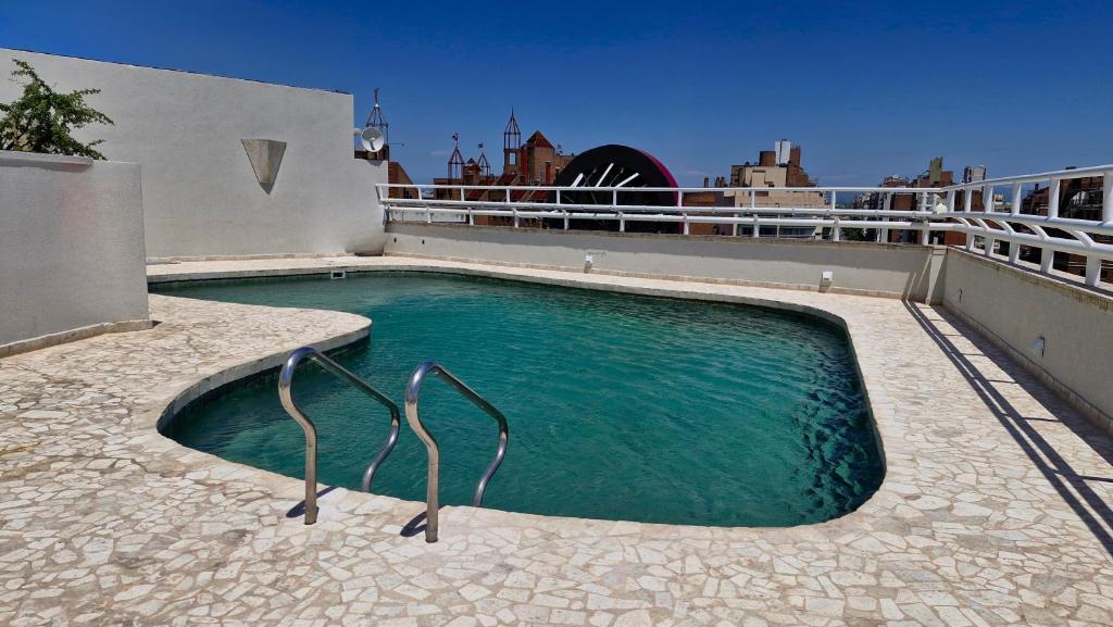 a swimming pool on the roof of a house at Amérian Executive Córdoba in Cordoba