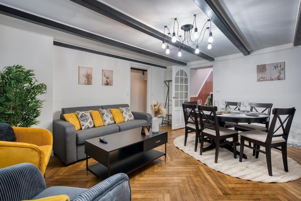 un salon avec un canapé et une table dans l'établissement Alicia - Appartement RDC - Parking gratuit, à Concarneau