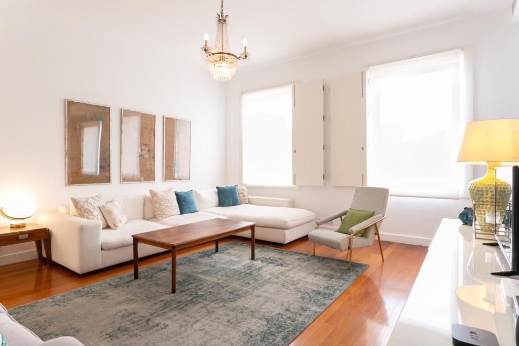 a living room with a white couch and a table at Apartment Carmo in Lisbon