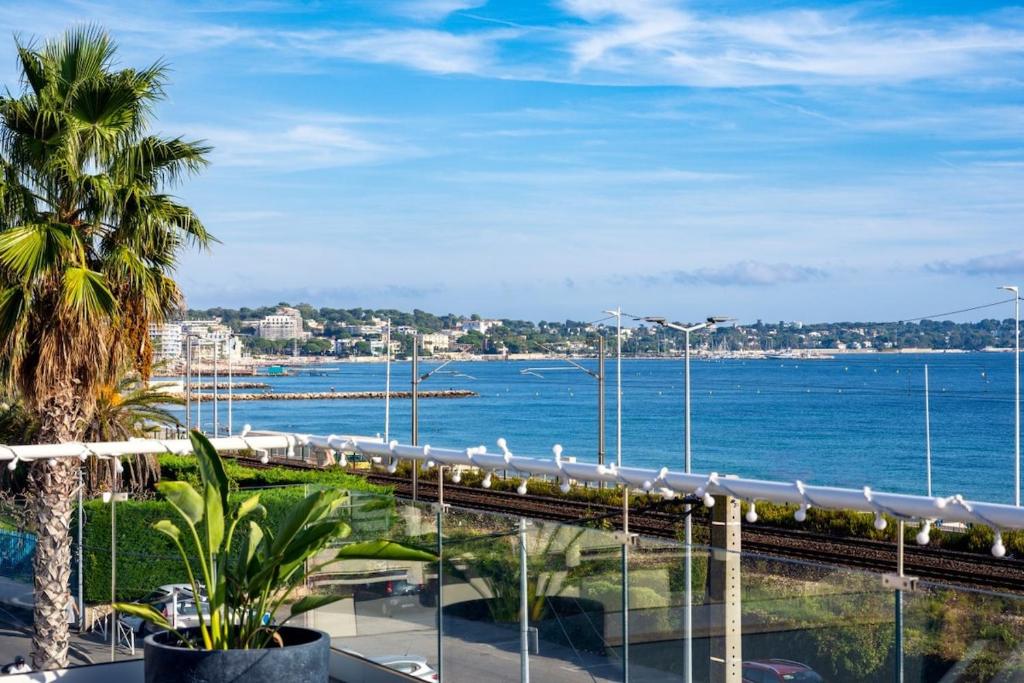 a view of the ocean from a hotel balcony at Private Front Beach Villa with garden and garage in Antibes