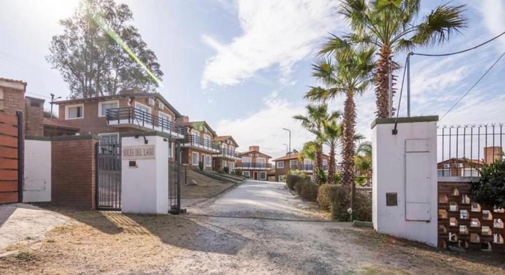 a street with some houses and palm trees at Soles del lago in Villa Carlos Paz