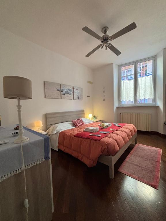 a bedroom with a bed and a ceiling fan at La Casa Dell'Amore Perfetto in Genova