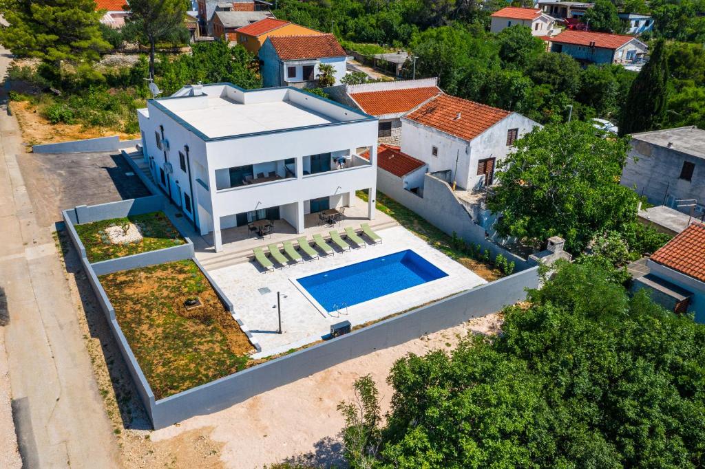an aerial view of a house with a swimming pool at Apartment ILUX-2 in Novigrad Dalmatia