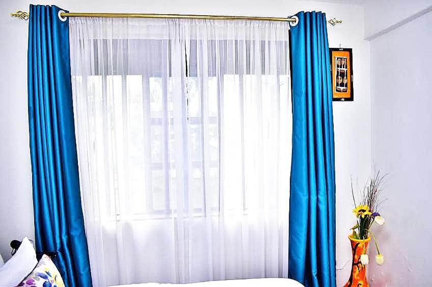 Postel nebo postele na pokoji v ubytování Bomani -3 Nati Apartment