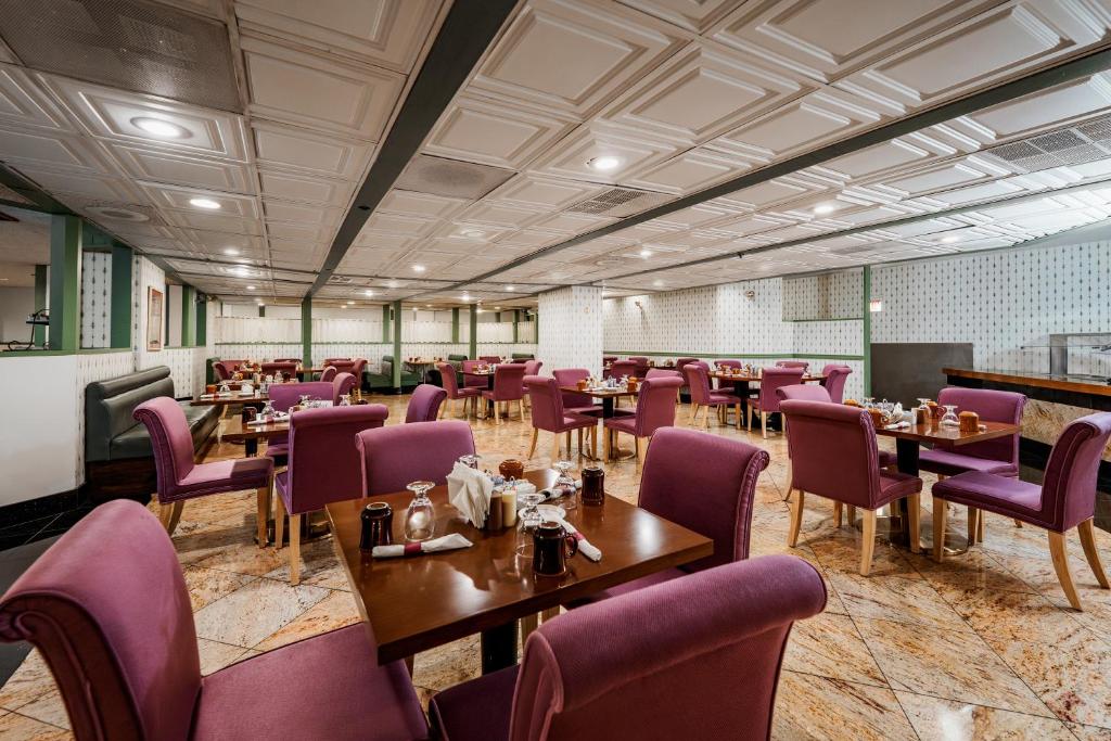 a dining room with tables and purple chairs at Congress Plaza Hotel Chicago in Chicago