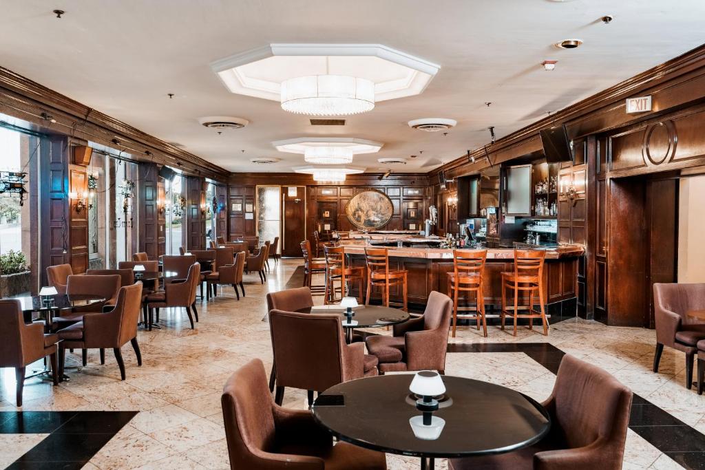 a restaurant with tables and chairs and a bar at Congress Plaza Hotel Chicago in Chicago