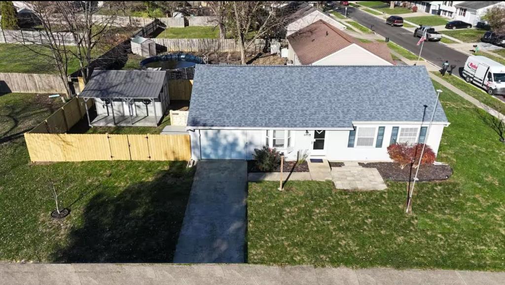 an aerial view of a white house with a yard at Private Ranch - Entire Home - 3 Bed Room - Hot Tub - King Bed - Fenced Yard - Pets & Kids Welcome - Game Shed - Free WiFi in Columbus