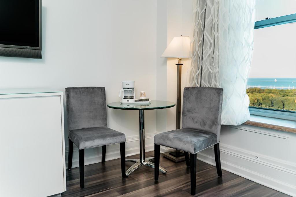 a room with two chairs and a table and a window at Congress Plaza Hotel Chicago in Chicago