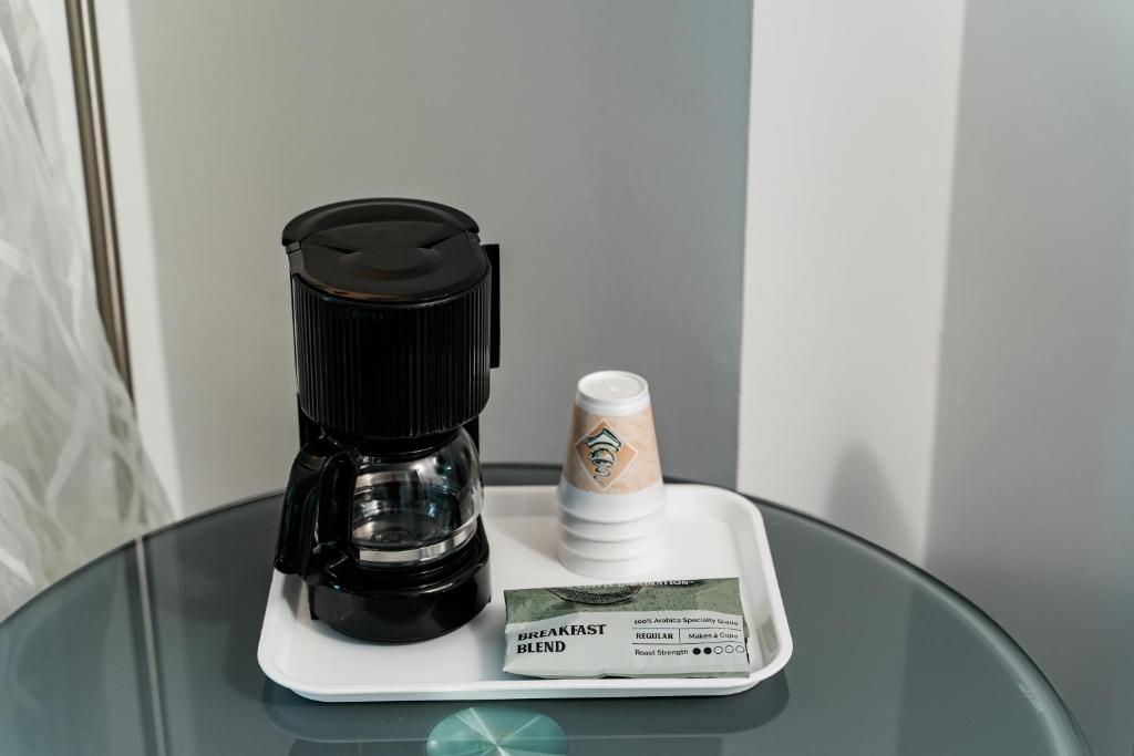 a coffee maker sitting on top of a glass table at Congress Plaza Hotel Chicago in Chicago