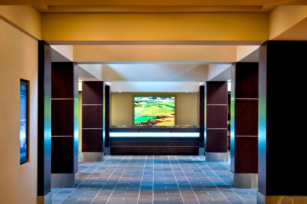 a hallway in a building with a painting on the wall at Trumbull Marriott Shelton in Trumbull