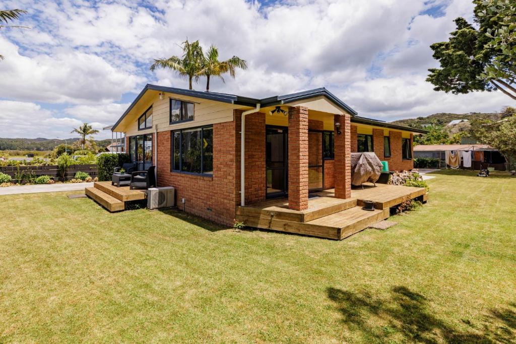 a tiny house with a large yard at Rangimarie - Paihia Holiday Home in Paihia