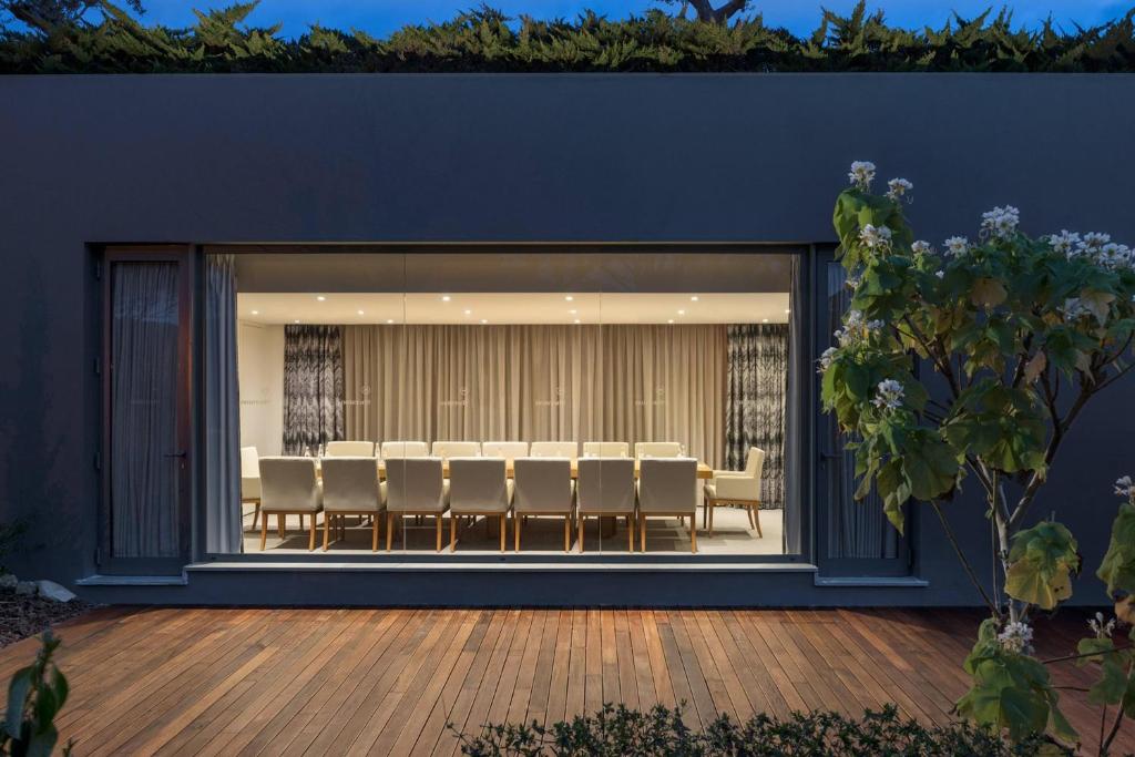 a room with a large window with chairs and a table at Sheraton Cascais Resort - Hotel & Residences in Cascais