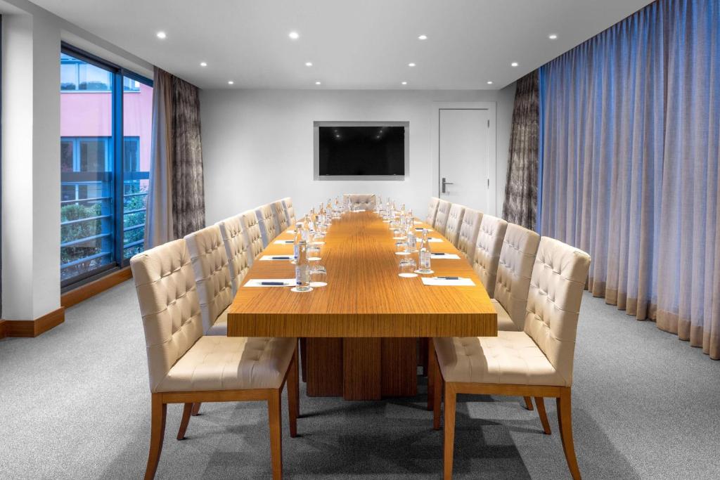 a conference room with a long wooden table and chairs at Sheraton Cascais Resort - Hotel & Residences in Cascais