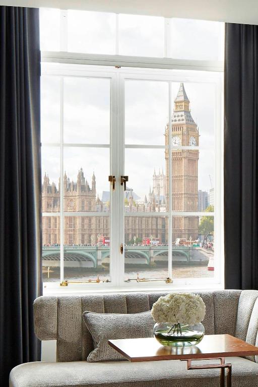 a living room with a large window with big ben at London Marriott Hotel County Hall in London