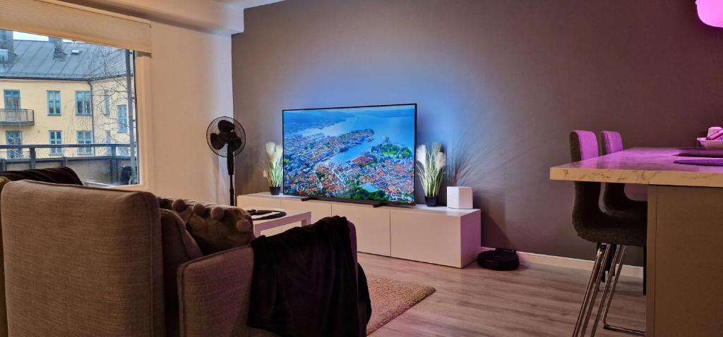 a living room with a flat screen tv on a wall at Modern and Central Apartment, 6 mins to Oslo City in Oslo
