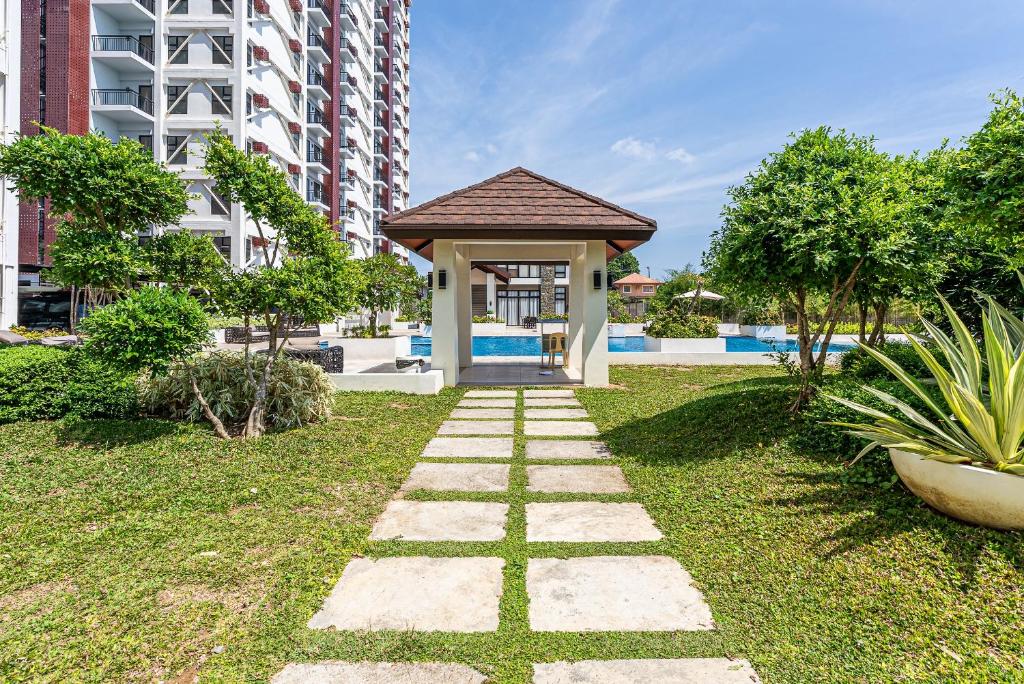 a walkway in a yard with a gazebo at Stylish Mactan Stay Near Airport 2-6 guest in Sudtungan