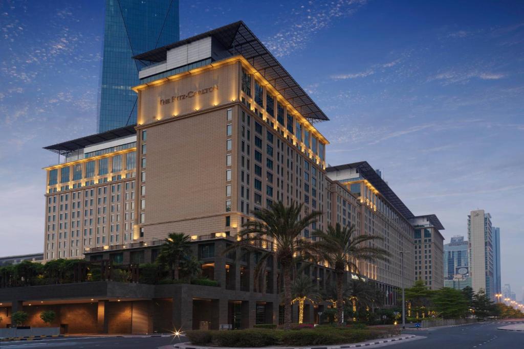 a tall building with lights on the side of it at Ritz Carlton DIFC Downtown Dubai in Dubai