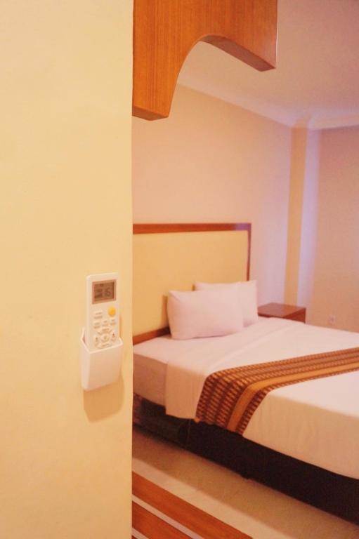 Postel nebo postele na pokoji v ubytování Sultan Hotel Banda Aceh