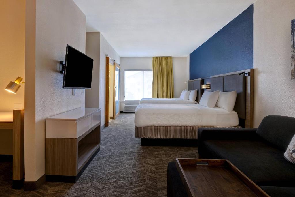 a hotel room with two beds and a couch at SpringHill Suites by Marriott Las Cruces in Las Cruces