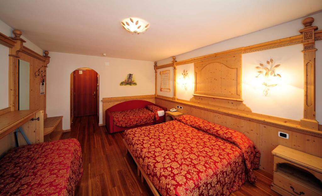 Łóżko lub łóżka w pokoju w obiekcie Hotel Dalla Serra