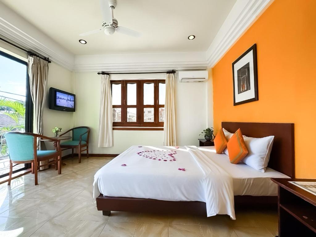 Postel nebo postele na pokoji v ubytování VPlus Hotel