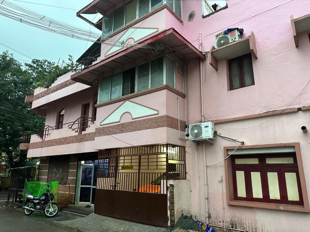 a pink building with a bike parked in front of it at Villa De Pondicherry in Puducherry