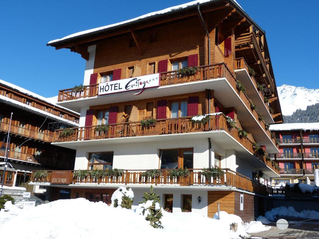 a hotel building with snow on the ground at Hotel Ermitage Verbier in Verbier