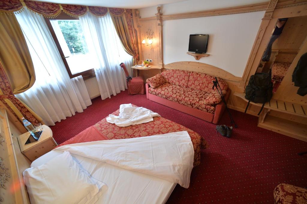 Łóżko lub łóżka w pokoju w obiekcie Hotel Dalla Serra