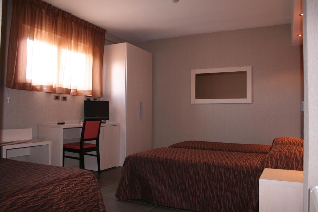 Postel nebo postele na pokoji v ubytování Hotel Cavour