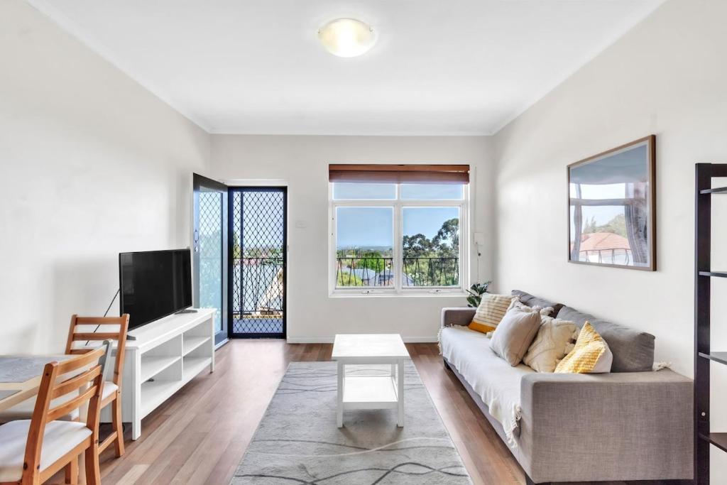 a living room with a couch and a tv at Charming Modern Retreat with Scenic View - Burnside in Burnside