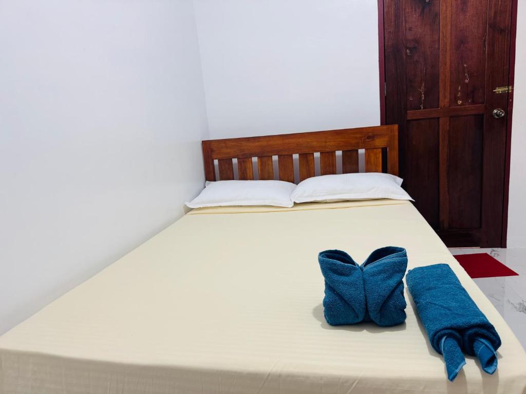 Postel nebo postele na pokoji v ubytování Baron Tourist Inn