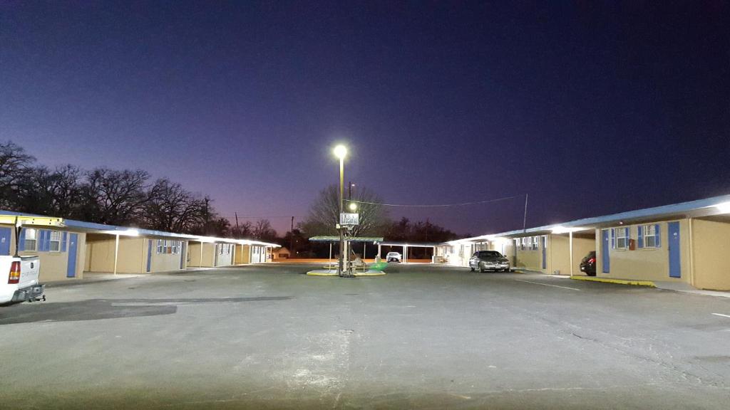 a parking lot in front of a building with a street light at Royal Inn in Early