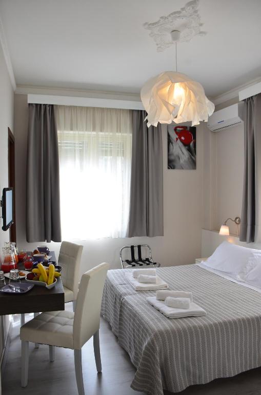 A bed or beds in a room at Athena Charming Rooms