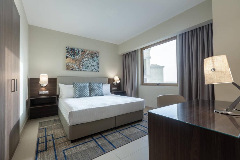 a hotel room with a bed and a desk at Residence Inn by Marriott Algiers Bab Ezzouar in Alger