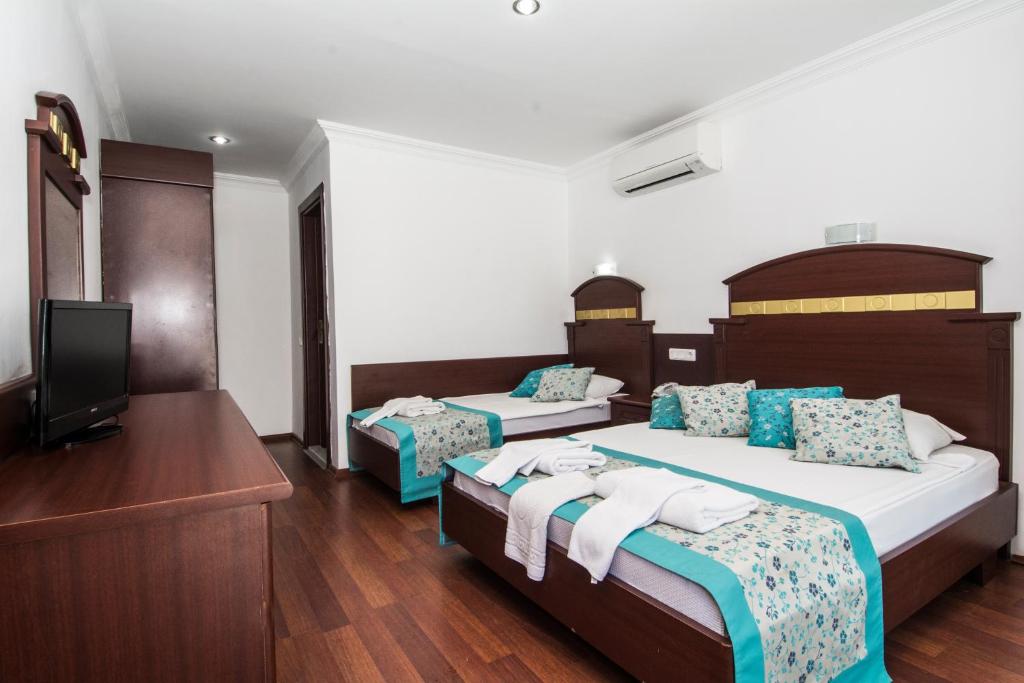 Postel nebo postele na pokoji v ubytování Sunberk Hotel