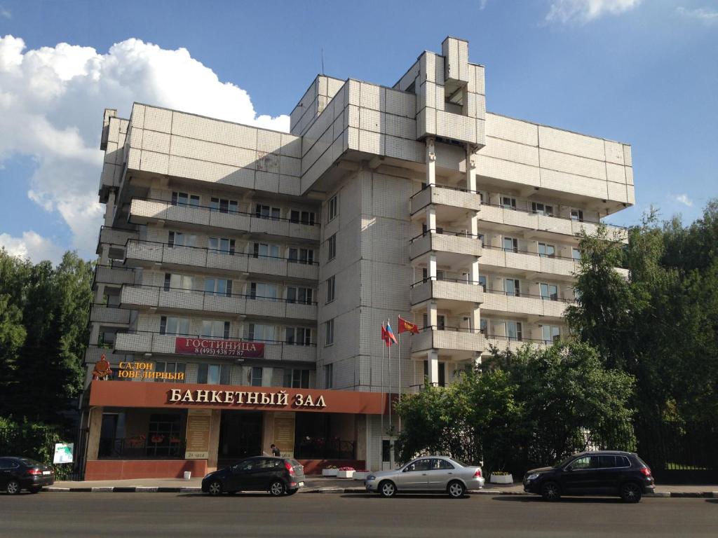 a building with cars parked in front of it at Hotel Complex Troparevo in Moscow