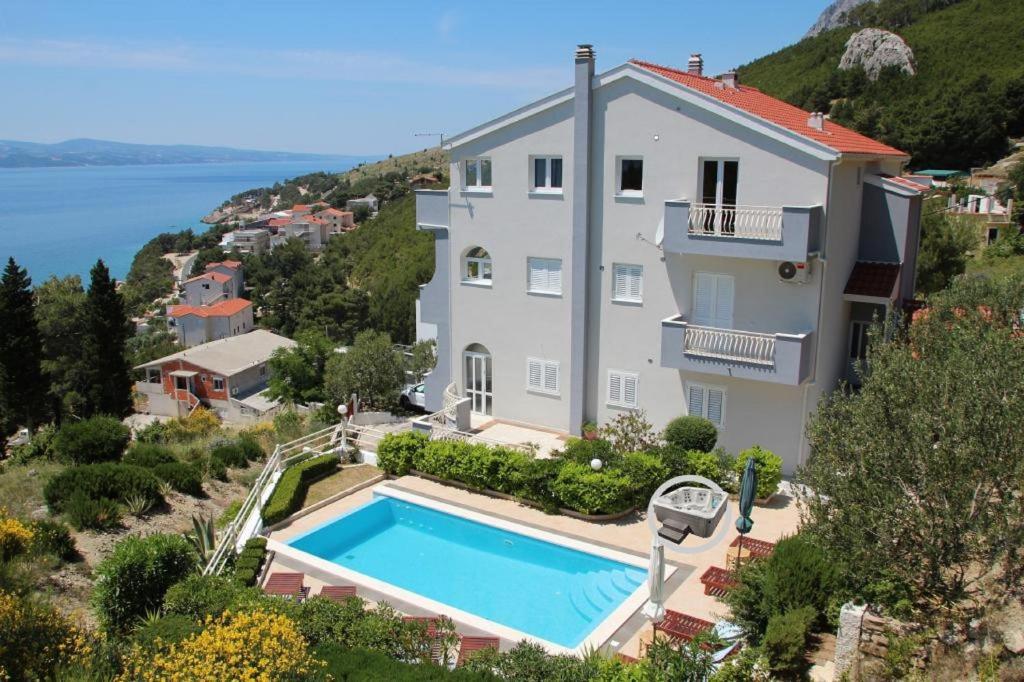 an image of a house with a swimming pool at Apartment Tafra 4 in Lokva Rogoznica