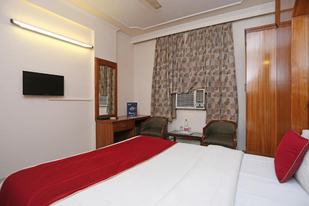 Postel nebo postele na pokoji v ubytování Hotel O Gold Palace