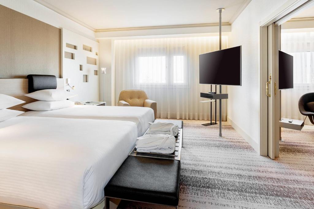 A bed or beds in a room at Madrid Marriott Auditorium Hotel & Conference Center