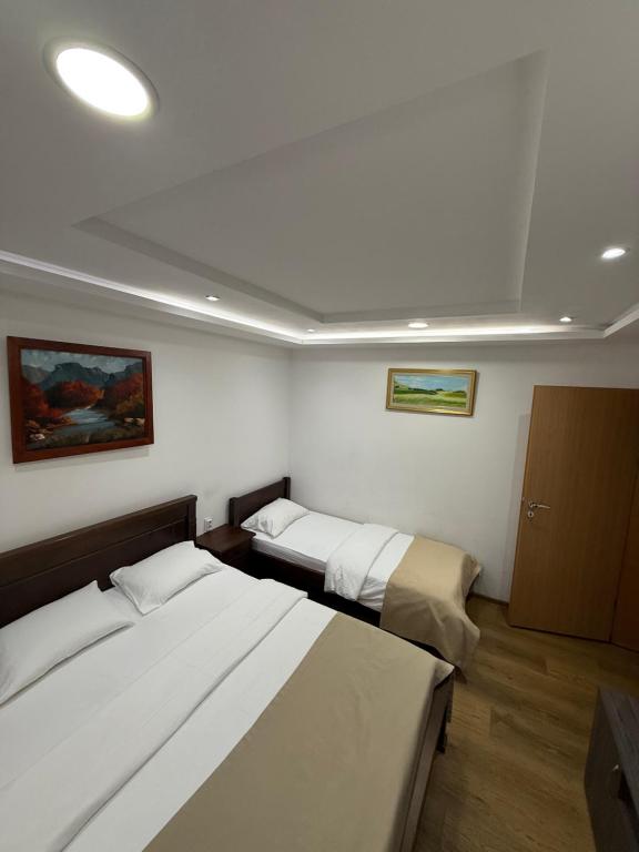 Postel nebo postele na pokoji v ubytování Hotel Pavlović