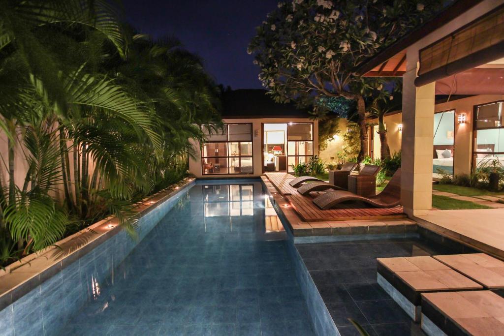 a swimming pool in the backyard of a house at Samana Villas in Legian