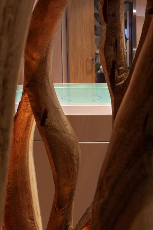 a bathroom with a tub and a mirror and a sink at Costa Rica Bibione SPA in Bibione