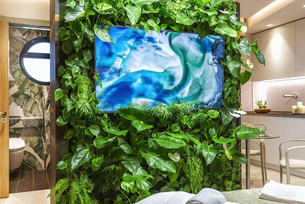 a wall covered in green plants in a room at Costa Rica Bibione SPA in Bibione
